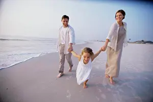 Rolled Up Sleeves Prints: Couple with their daughter on the beach