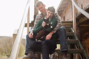Above 18 Prints: A couple holding and petting a cat