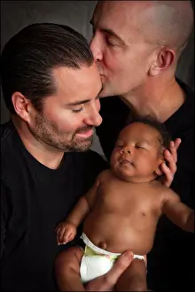 Father Prints: Couple Kissing While Holding Baby