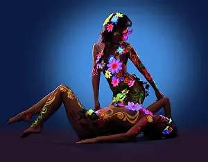 Chic Prints: Couple of Naked women posing with glow ultraviolet body art and flowers
