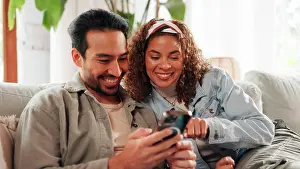 Conversation Prints: Couple, relax and smile on sofa with phone for social media