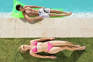 Unwind Prints: Couple sunbathing at the pool