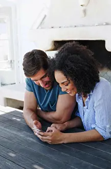 Quality Time Prints: Couple using smartphone in beach house