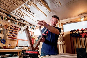 Industrious Prints: Craftsman preparing parts for wooden object