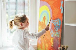 Talent Prints: Creative blond girl in casual clothes sitting on window sill against window