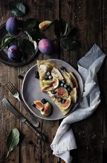 Lunch Prints: Crepes with figs and blackberries on wooden table. Top view