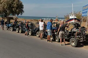 Crete Prints: Crete, Greece, Europe. @2022. Twin seat quad bikes and passengers take a break from their safari at Potamos Beach