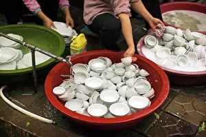 Thirty Prints: Crockery being washing in tubs outside