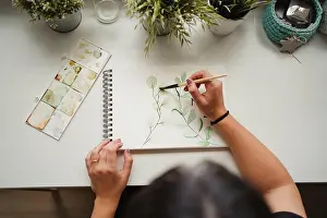 Anonymous Prints: Crop from above view of unrecognizable woman drawing picture with watercolors at home in Paris