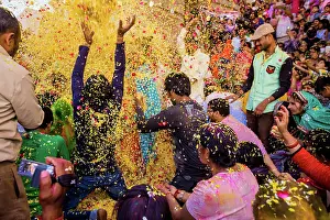 Holi Prints: Crowd throwing flower petals during the Flower Holi Festival
