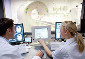 Top Section Prints: CT scanning. Radiographers taking a computed tomography CT scan of a patient