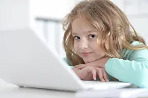 Gadget Prints: Cute and happy little girl children using laptop computer Cute and happy little girl children using laptop computer