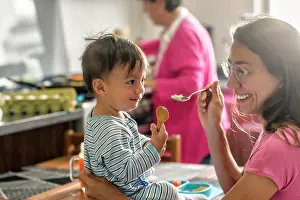 Baby Boomer Prints: Cute latin Mom sharing smiles with her son at breakfast