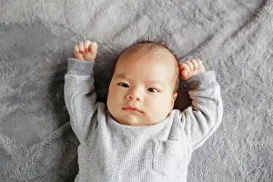 Innocent Prints: Cute two months newborn Asian Chinese baby boy lying on bed looking