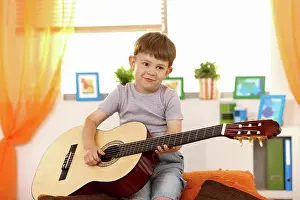 Alter Prints: Cute small kid with guitar Cute small kid having fun with guitar at home
