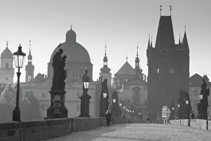 Jogging Prints: Czech Republic, Prague. Dawn view of Charles Bridge, Bridge Tower and old town buildings