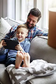 Browsing Prints: Dad, boy and house on couch with tablet