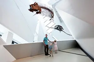 Extinct Prints: Dad with little girl and boy looking at dinosaur fossils at Royal Ontario Museum