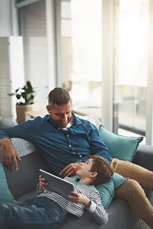 Parenting Prints: Dad, smile and child with tablet on sofa for online movie