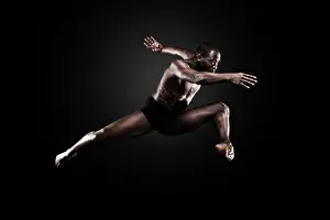Athleticism Prints: Dancer Lloyd Boyd mid air against a dark background. Bodies in Action