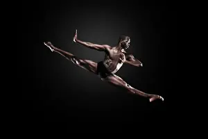Athleticism Prints: Dancer Lloyd Boyd mid air against a dark studio background. Bodies in Action