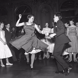 50 S Prints: Dancing in the 1950s. A young couple is dancing and moving to the music