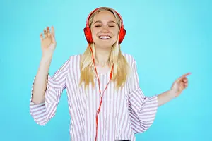 Sound Prints: Dancing girl listens to music in earphones Dancing girl listens to music in earphones