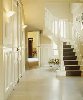 Dark grey carpet on white staircase in white hall with white flooring