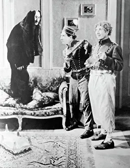 Races Prints: A Day At The Races'. Groucho in disguise eludes Chico with tray and Harpo with seltzer