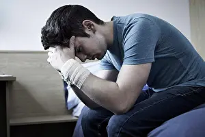 Cutting Prints: Depressed Young Man With Bandaged Wrists After Suicide Attempt