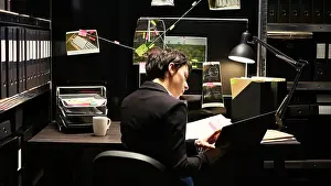 Case Prints: Detective reads valuable information