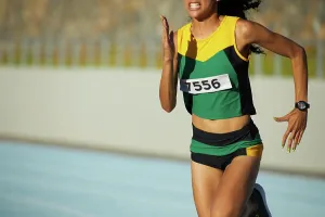 Runner Prints: Determined female track and field athlete running in competition
