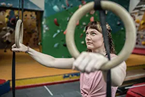 Determined Prints: Determined young woman at gymnastics rings