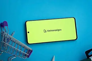 Communications Prints: Dhaka, Bangladesh- 03 July 2025: Smartphone displaying Kleinanzeigen logo with shopping cart on a blue background