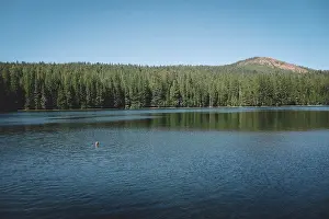 Tent Prints: Distant View of Boy Treading Water in the Center of a Scenic Lake