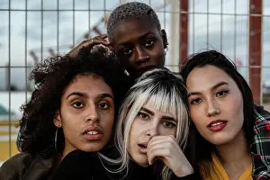 Diverse Prints: Diverse group of smiling women hugging together on lawn