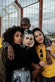 Diverse Prints: Diverse group of smiling women hugging together on lawn
