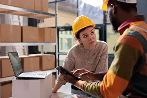 Logistics Prints: Diverse stockroom team checking online orders on tablet computer