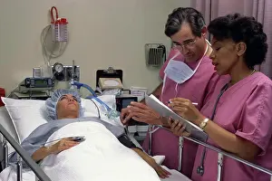 Chart Prints: Doctor attending to a patient with a nurse