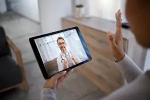 Video Prints: Doctor consulting patient on video call screen for telehealth communication