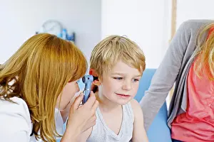 Examination Prints: Doctor examining a child's ear