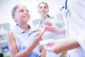 Small Group Prints: Doctor giving girl a finger prick test