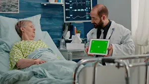 Rate Prints: Doctor holding horizontal green screen on digital tablet