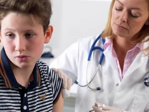 Vaccine Prints: Doctor injecting 10 year old boy a drug in a clinic
