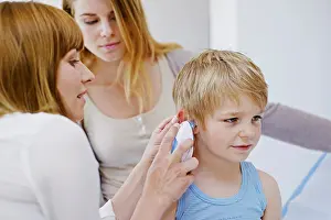 Examination Prints: Doctor measuring a child's temperature