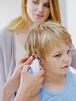 Examination Prints: Doctor measuring a child's temperature