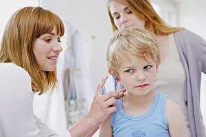 Examination Prints: Doctor measuring a child's temperature
