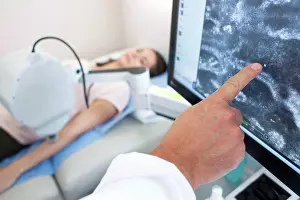 Examination Prints: Doctor pointing at computer screen, patient on bed