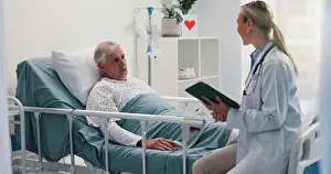 Notes Prints: Doctor with tablet, consulting and old man in hospital bed for healthcare