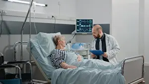 Hospital Ward Prints: Doctor talking to elder patient about disease and treatment